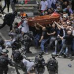 Israeli police beat mourners with batons at funeral procession for veteran journalist